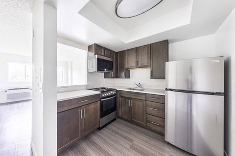 a kitchen with stainless steel appliances and wooden cabinets